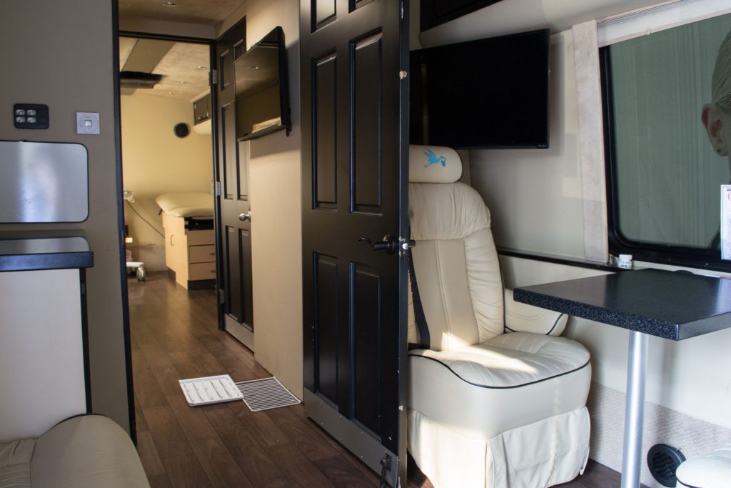 RV interior with leather chair and table